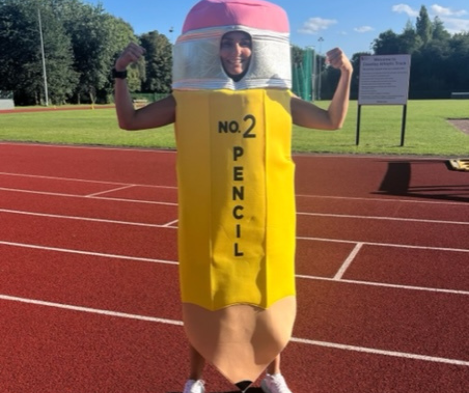 Belinda dressed as a pencil on a running track